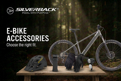 Silverback e-bike on a forest path with Giro Fixture MIPS helmet, Giro Xen gloves, AXA folding lock and Spectrum e-bike headlight beneath the E-Bike Accessories title