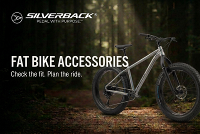 Silver-grey Silverback SE:Series Fat Explorer on a forest trail with Fat Bike Accessories title and white Silverback logo