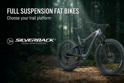 Silverback Synergy carbon full-suspension fat bike on a forest trail beneath a Full Suspension Fat Bikes title and white Silverback logo