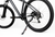 Close-up of a dark gray mountain bike with its kickstand deployed, showing the rear wheel, disc brake, chainring, and frame against a clean white background.