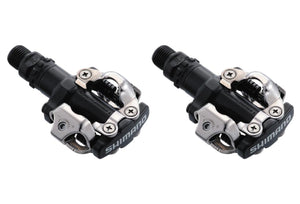Shimano PD-M520 double-sided SPD pedals in black, showcasing compact design and durability