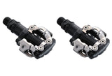 Shimano PD-M520 double-sided SPD pedals in black, showcasing compact design and durability