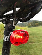 Lifestyle shot of cyclist using Spectrum Star bike light for safe night riding